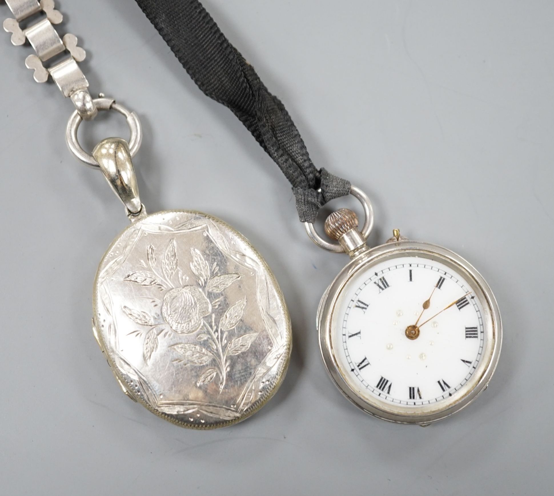 A lady's silver cased fob watch and a white metal oval locket on chain.